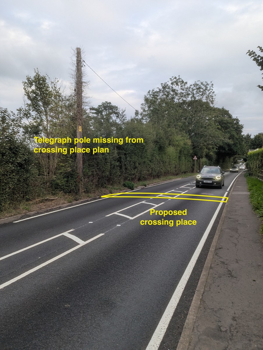 Station Road looking east from the site frontage, with the proposed crossing place marked in yellow across the carriageway, and the telegraph pole on the left labelled as missing from the crossing place plan